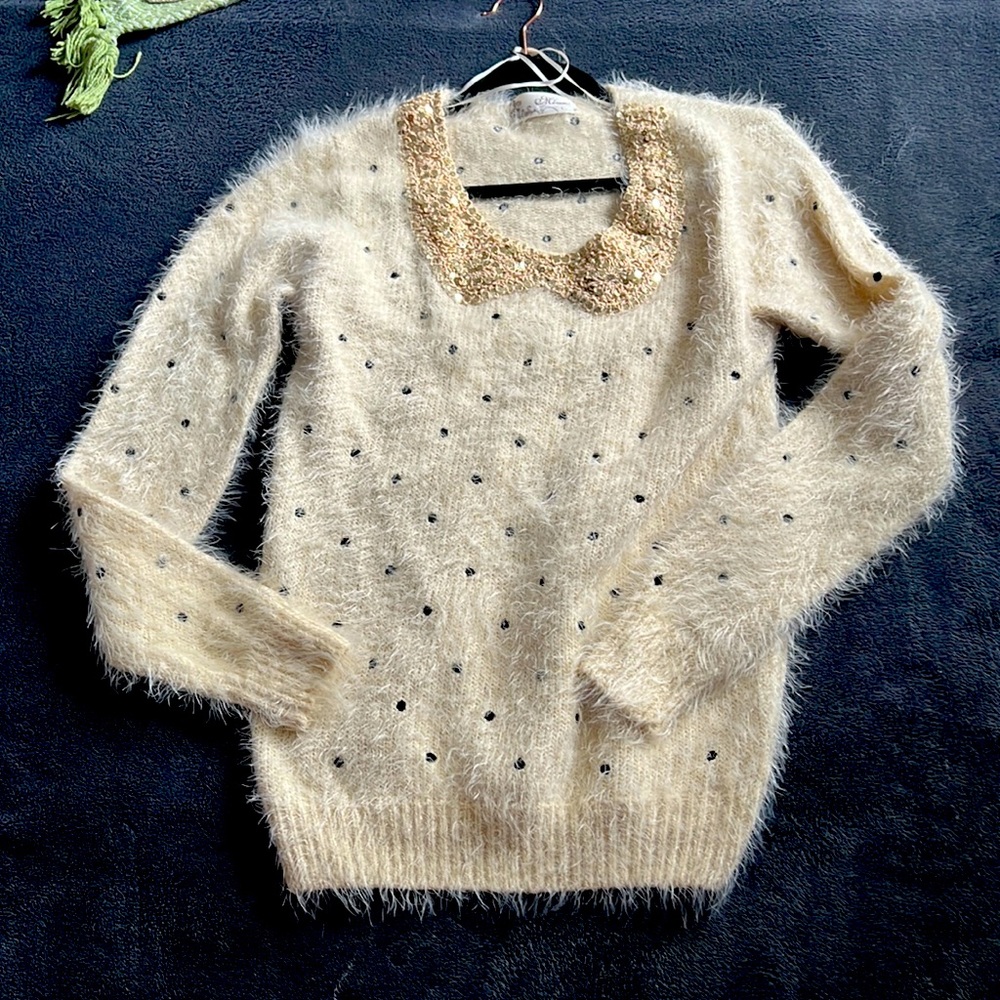 Cream fuzzy sweater with black dots and gold sequins neck line